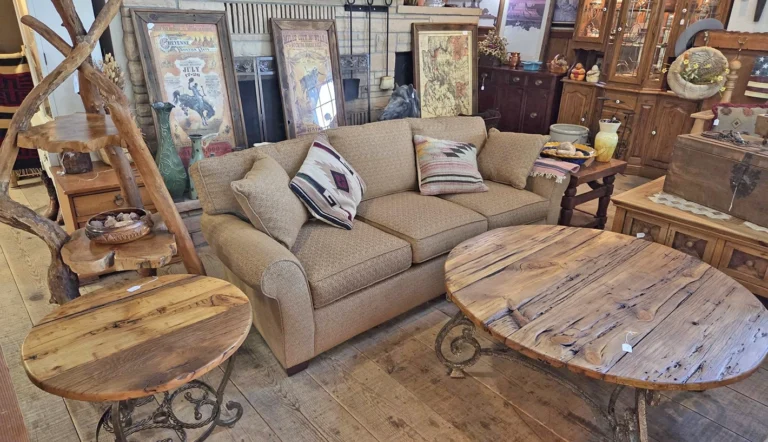 living room sofa with wall art, round barnwood side tables, coffee tables